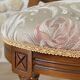 Antique Louis XVI style chair in wood and floral fabric.