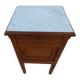 Antique bedside table with its marble top and white earthenware interior