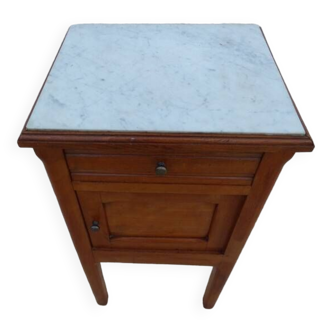 Antique bedside table with its marble top and white earthenware interior