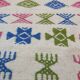 White carpet with Berber motifs pink green and blue