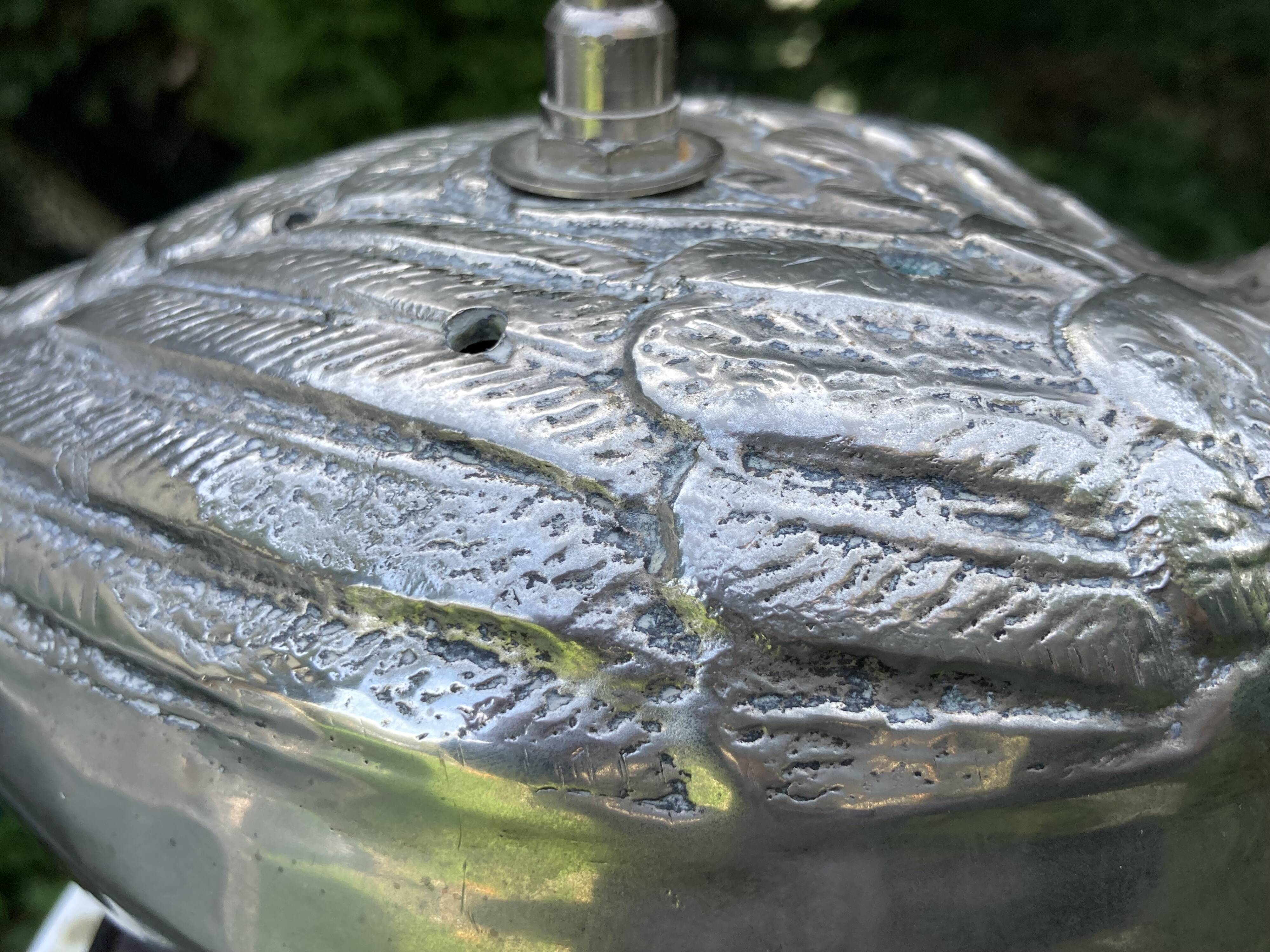 Old vintage lamp representing a duck in silver metal with wooden base