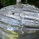 Old vintage lamp representing a duck in silver metal with wooden base
