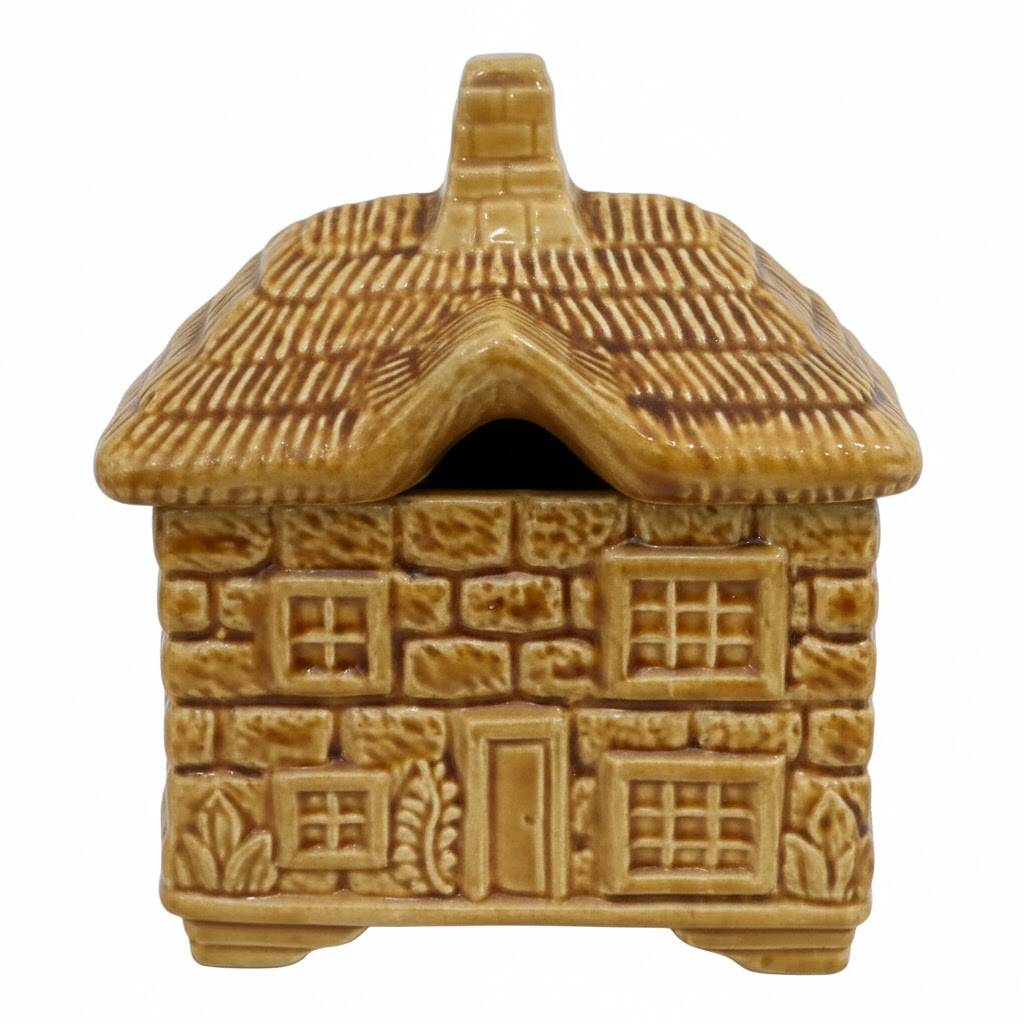 Devonway jam pot in the shape of a cottage with a thatched roof.