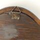 Antique wall mirror in carved wood with a wavy shape and a golden trim.