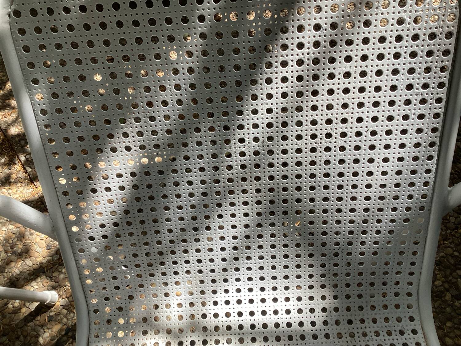 Perforated metal armchairs