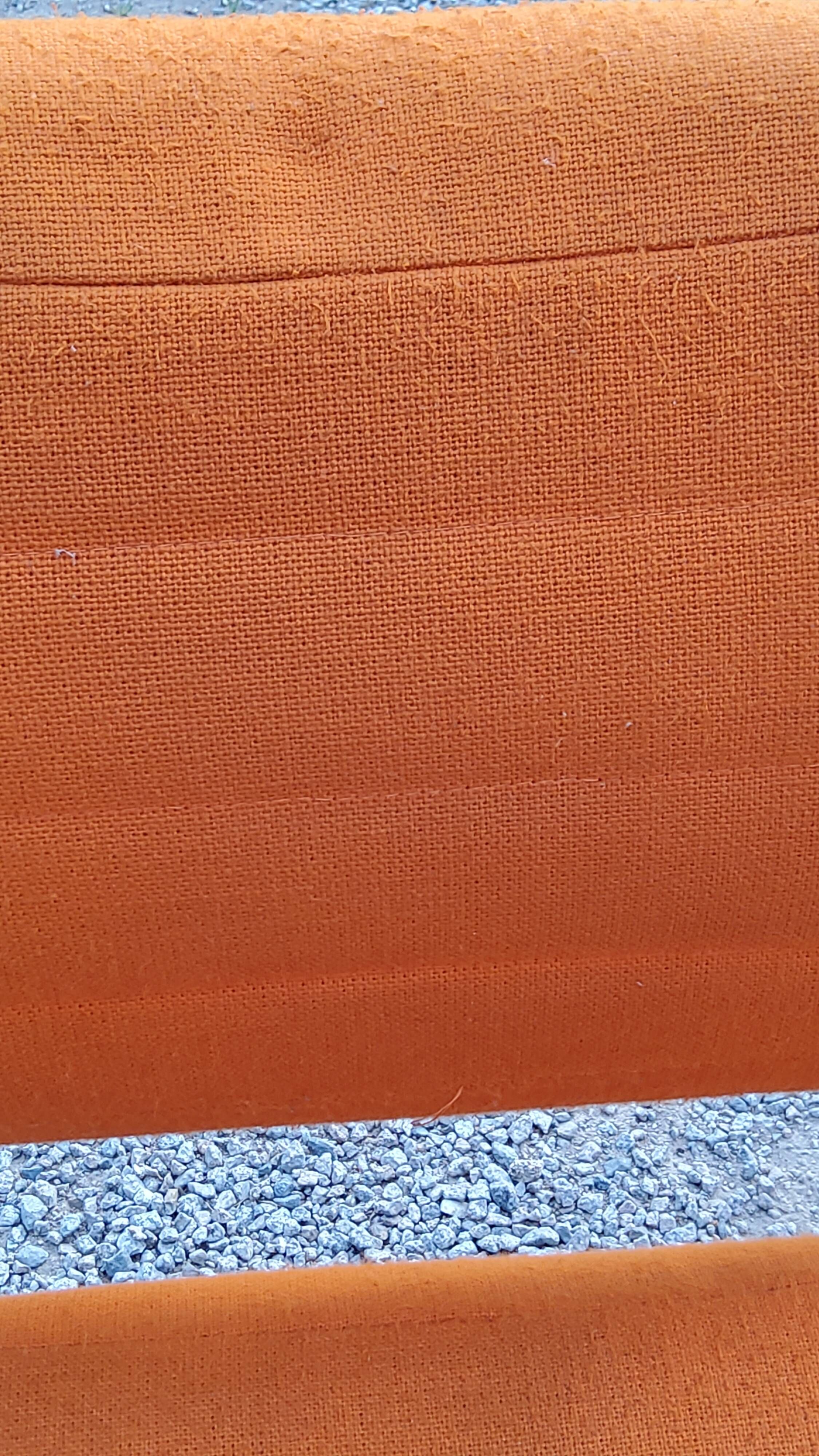 Pair of designer armchairs in orange fabrics and chrome tubes from the 70s
