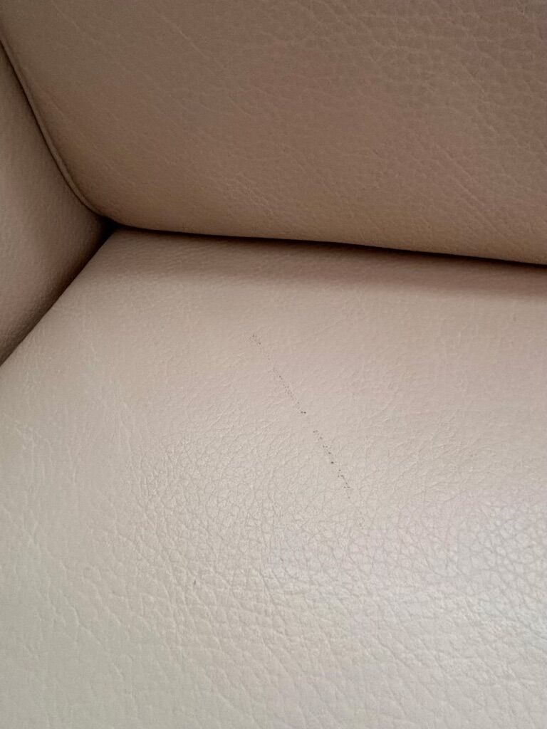 Beige leather sofa with solid wood frame