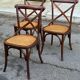 4 bistro chairs with curved wooden backs and cross braces / Crossback