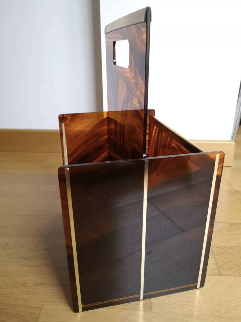 Tortoiseshell lucite magazine rack from the Christian Dior Home collection.