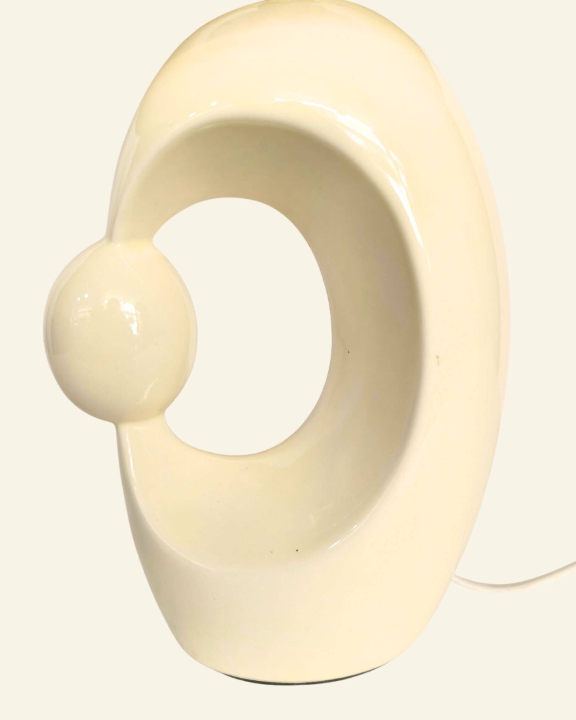 Cream ceramic table lamp with a mid-century design, featuring a lampshade.