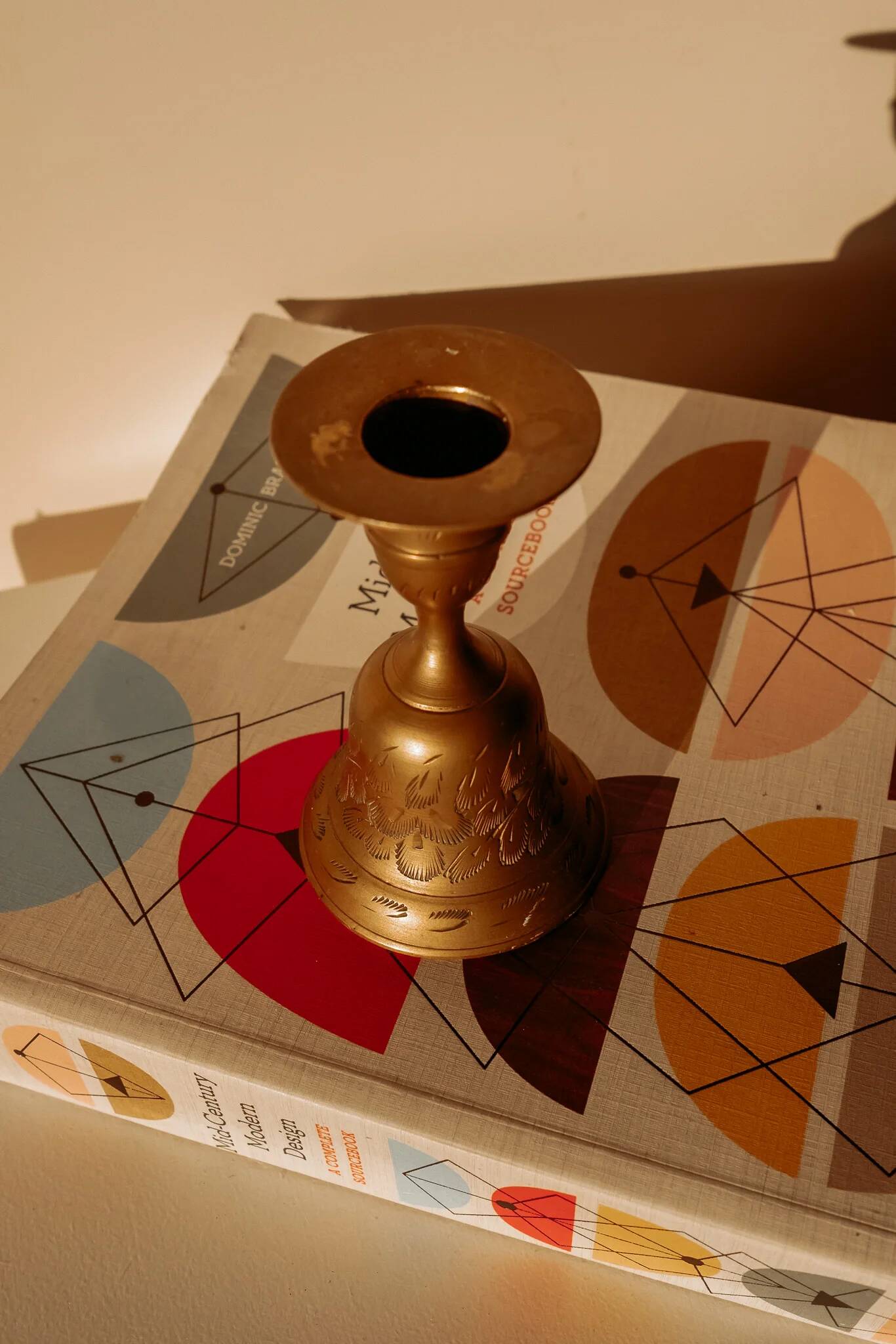 Brass candlestick in the shape of a bell.