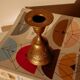 Brass candlestick in the shape of a bell.