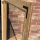 Restored antique oak display cabinet, black background, glass shelves.