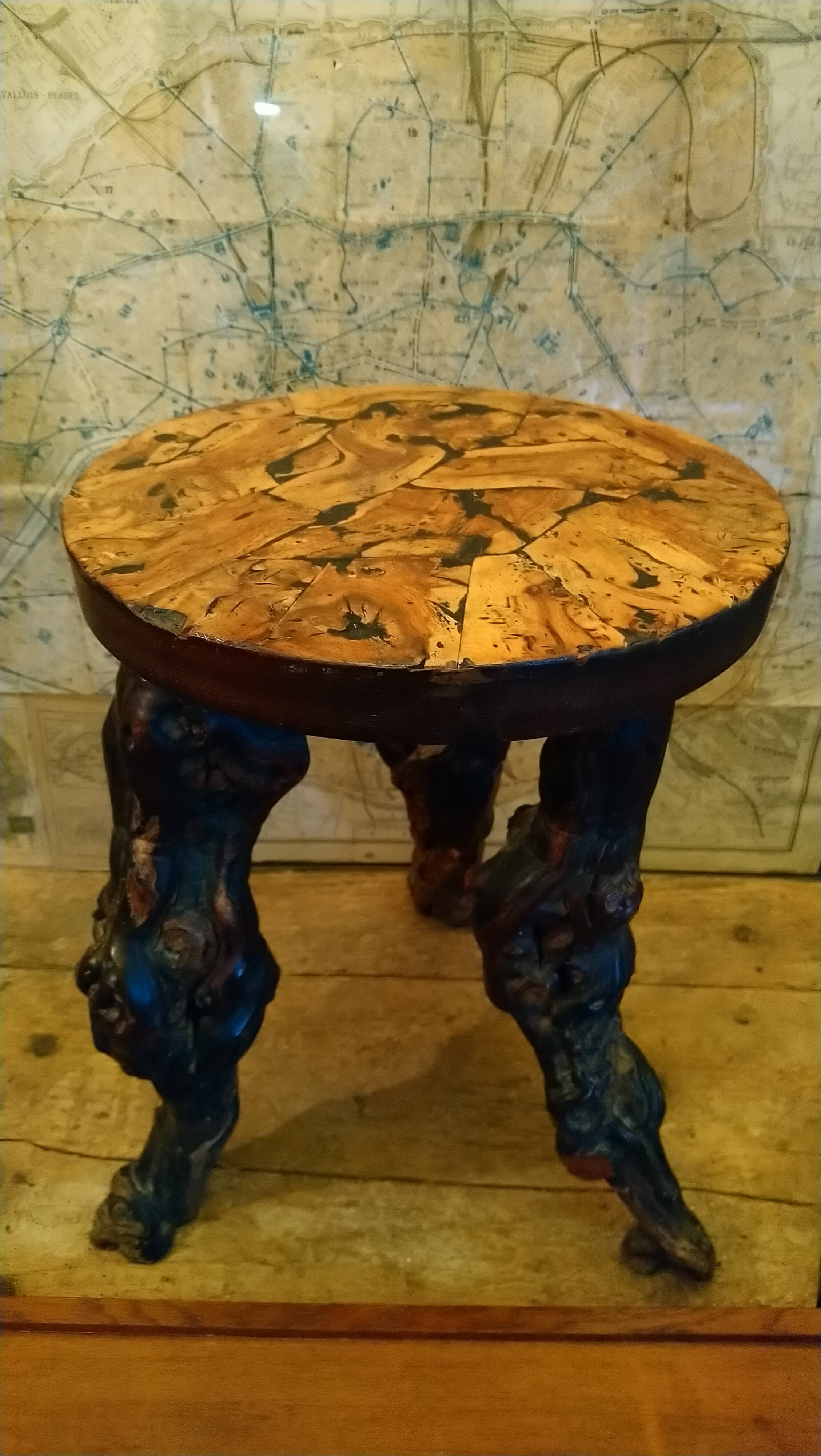 Brutalist tripod stool made from vine stumps.