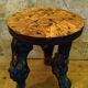 Brutalist tripod stool made from vine stumps.