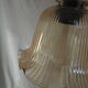 Suspension in a ribbed tulip shape, made of smoked glass.