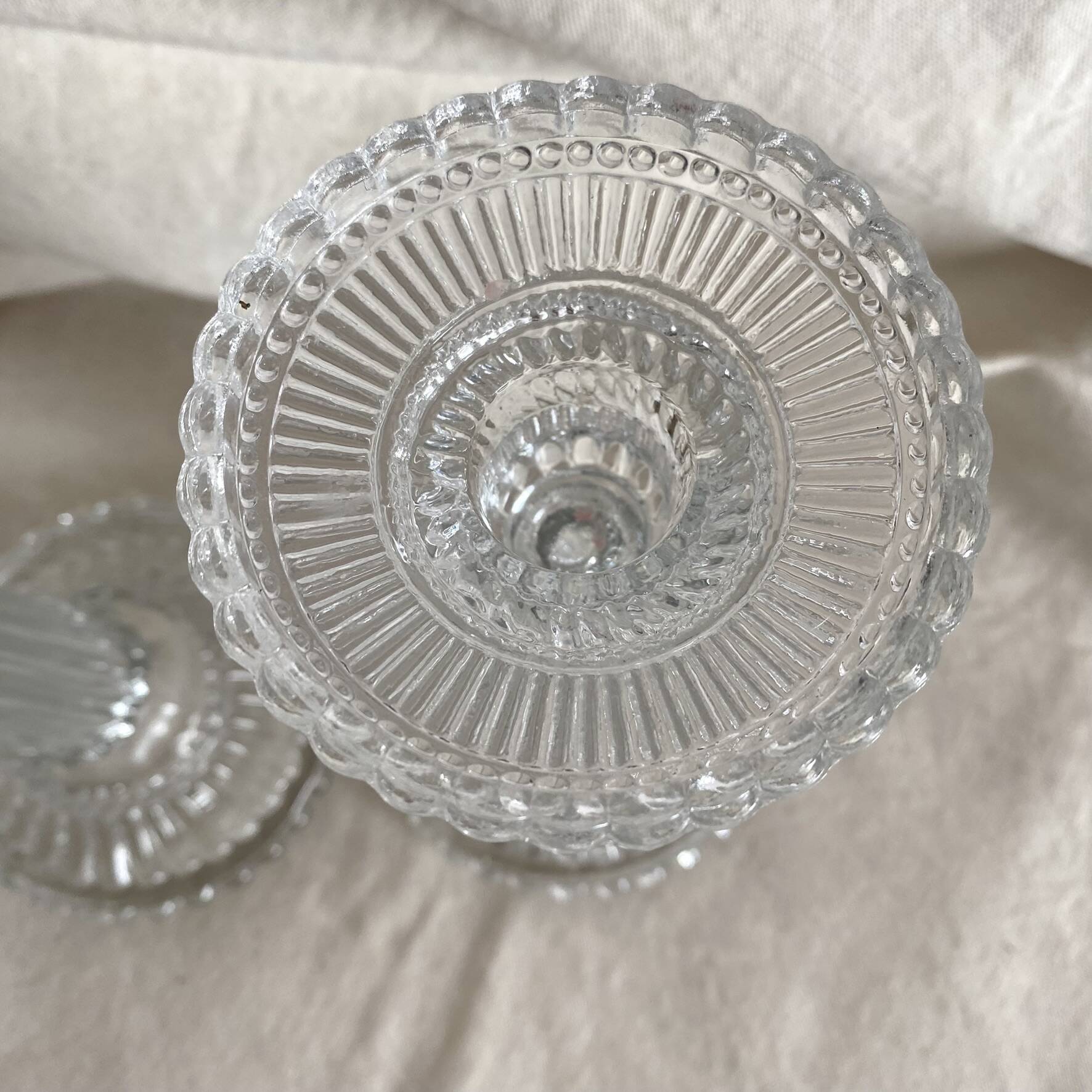 Column candle holders in moulded glass made in France.