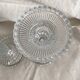 Column candle holders in moulded glass made in France.
