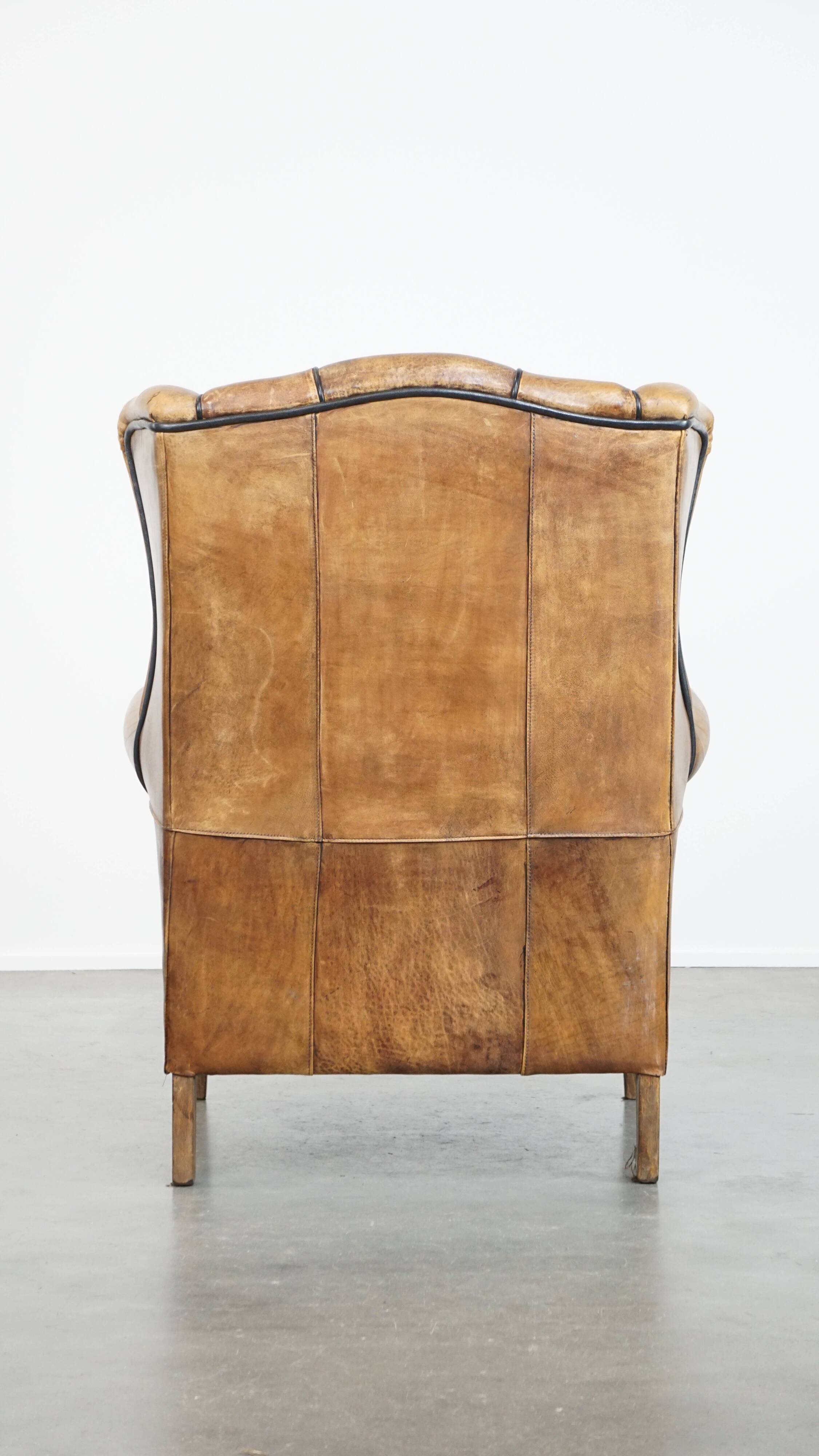 Sheep leather wingback chair finished with black piping