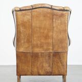 Sheep leather wingback chair finished with black piping