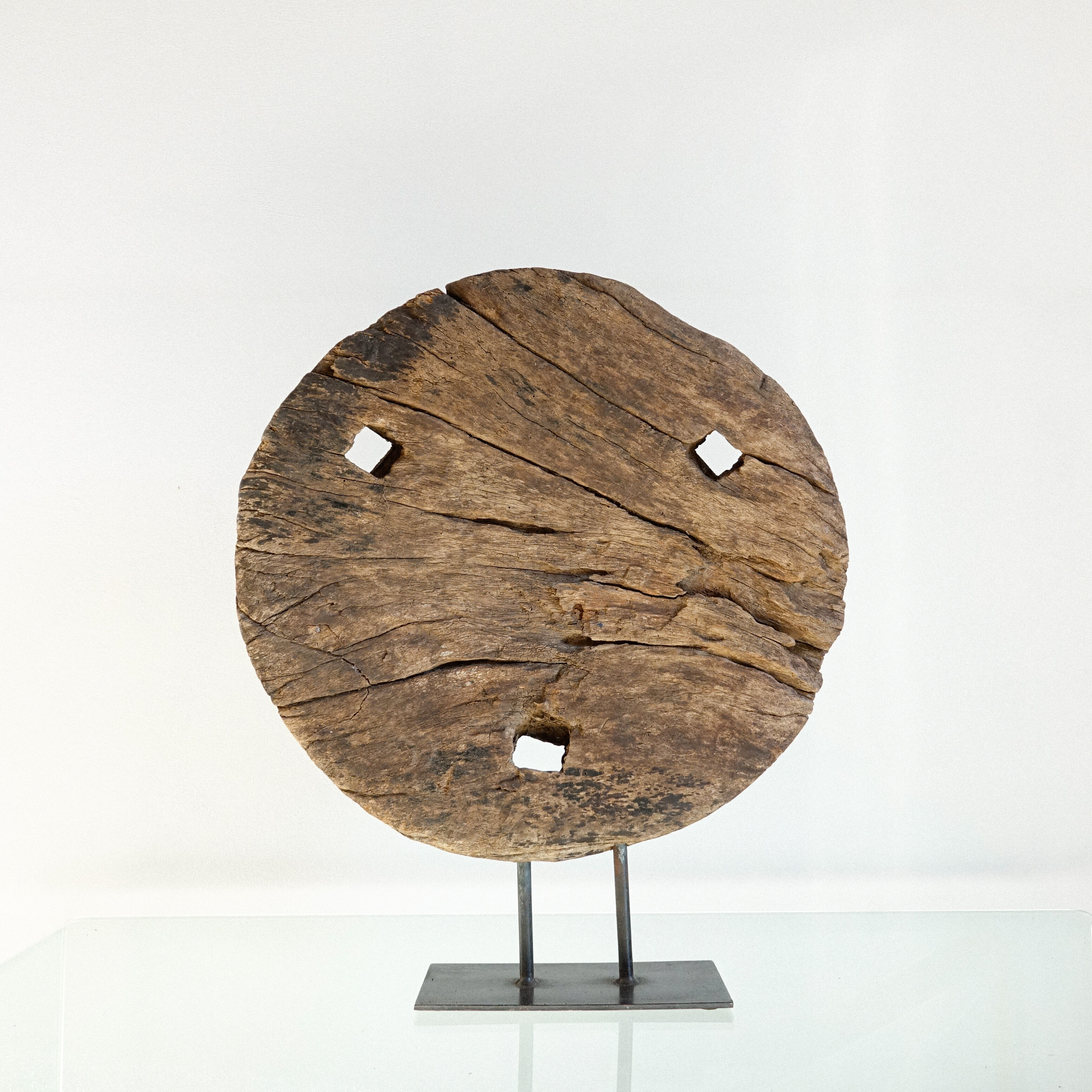 Old decorative wooden wheel on foot