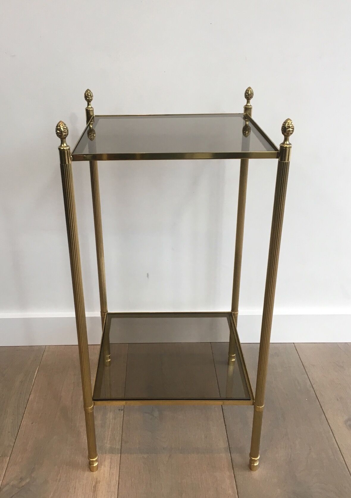 Pair of neoclassical style sofa ends in gilded metal and glass