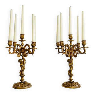 Solid bronze candlesticks decorated with putti, acanthus leaves and lion heads