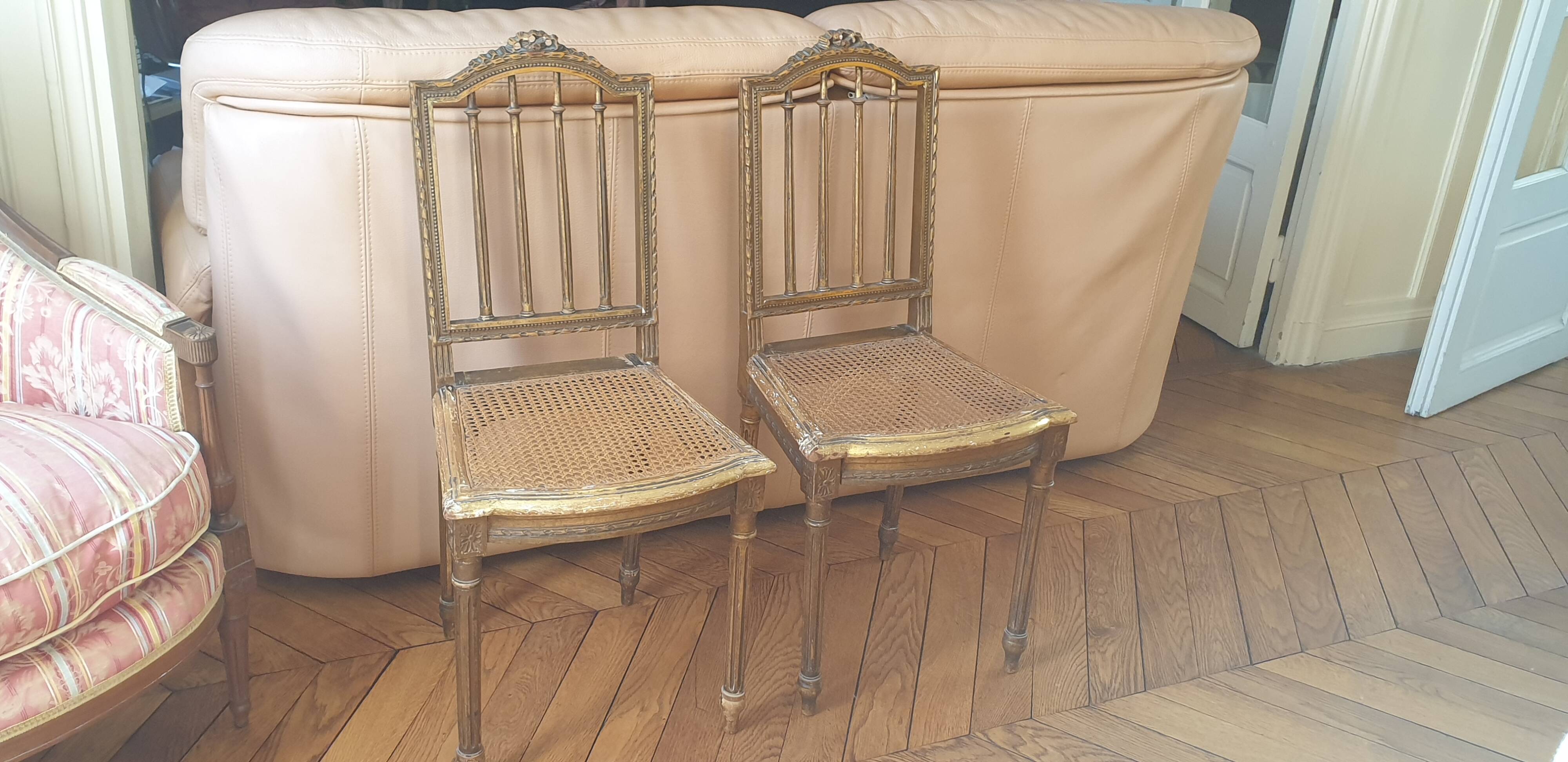 Pair of Louis XVI caned chairs with carved gilded wood.