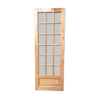 Old wooden door glazed with small tiles