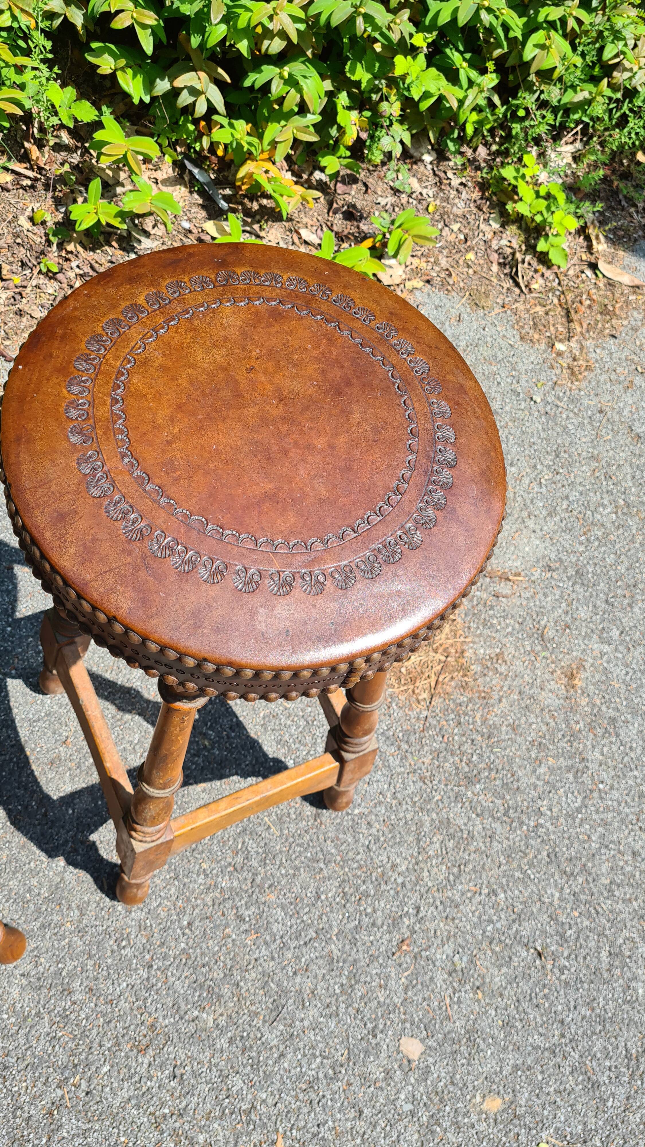 4 old leather and wood stools
