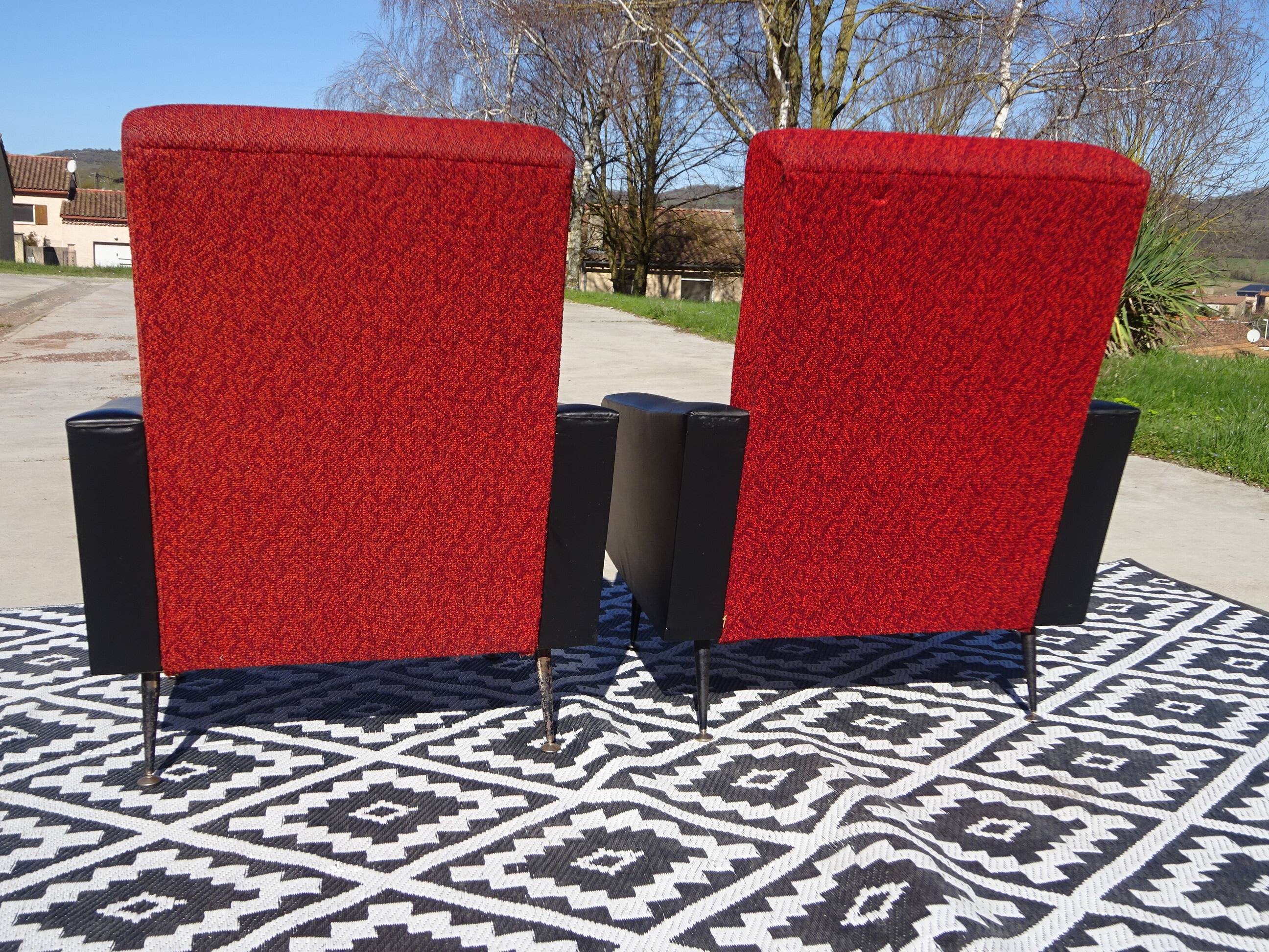 Vintage armchairs in red and black faux leather, the pair.