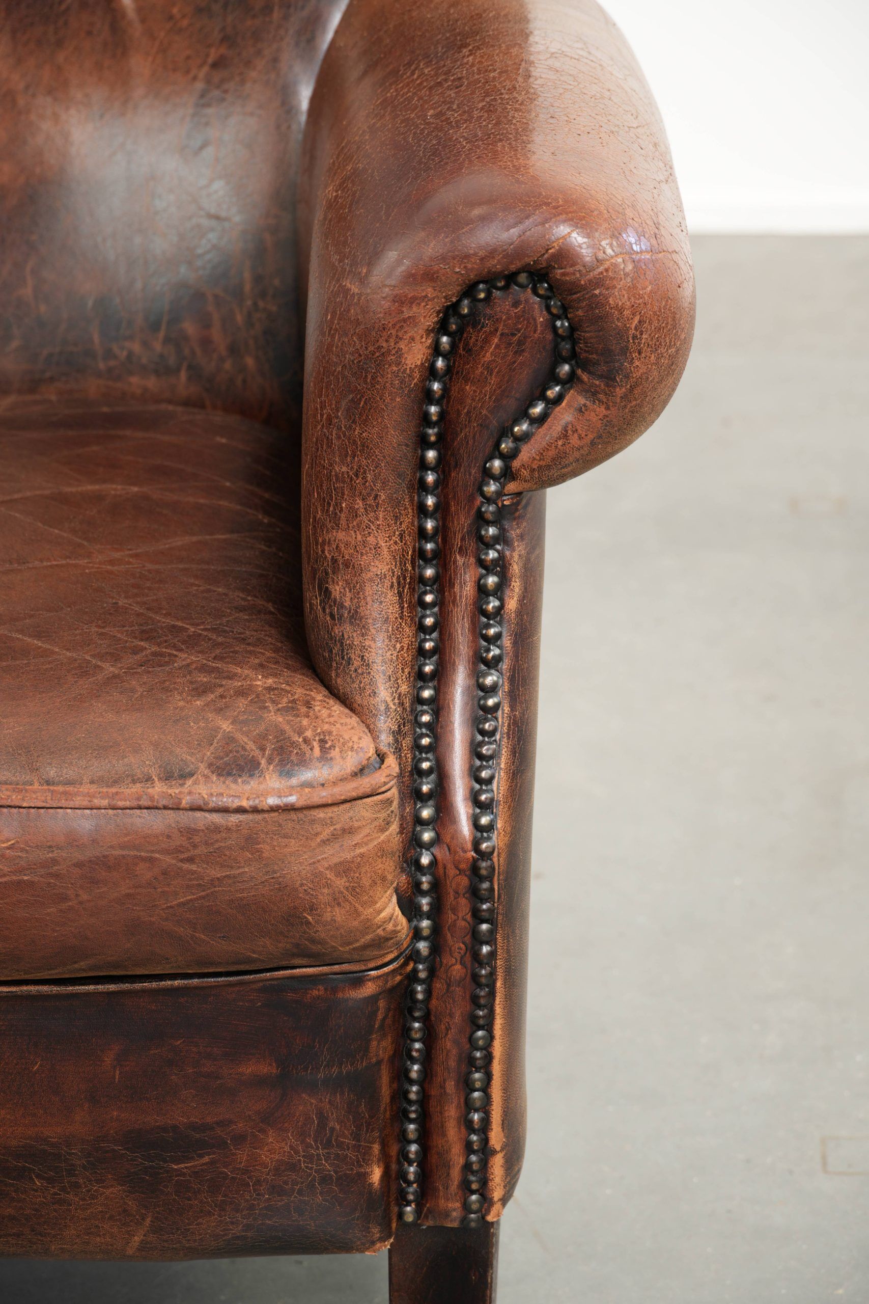 Vintage sheepskin wingback armchair in a deep brown colour finished
