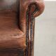 Vintage sheepskin wingback armchair in a deep brown colour finished