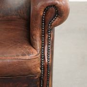 Vintage sheepskin wingback armchair in a deep brown colour finished