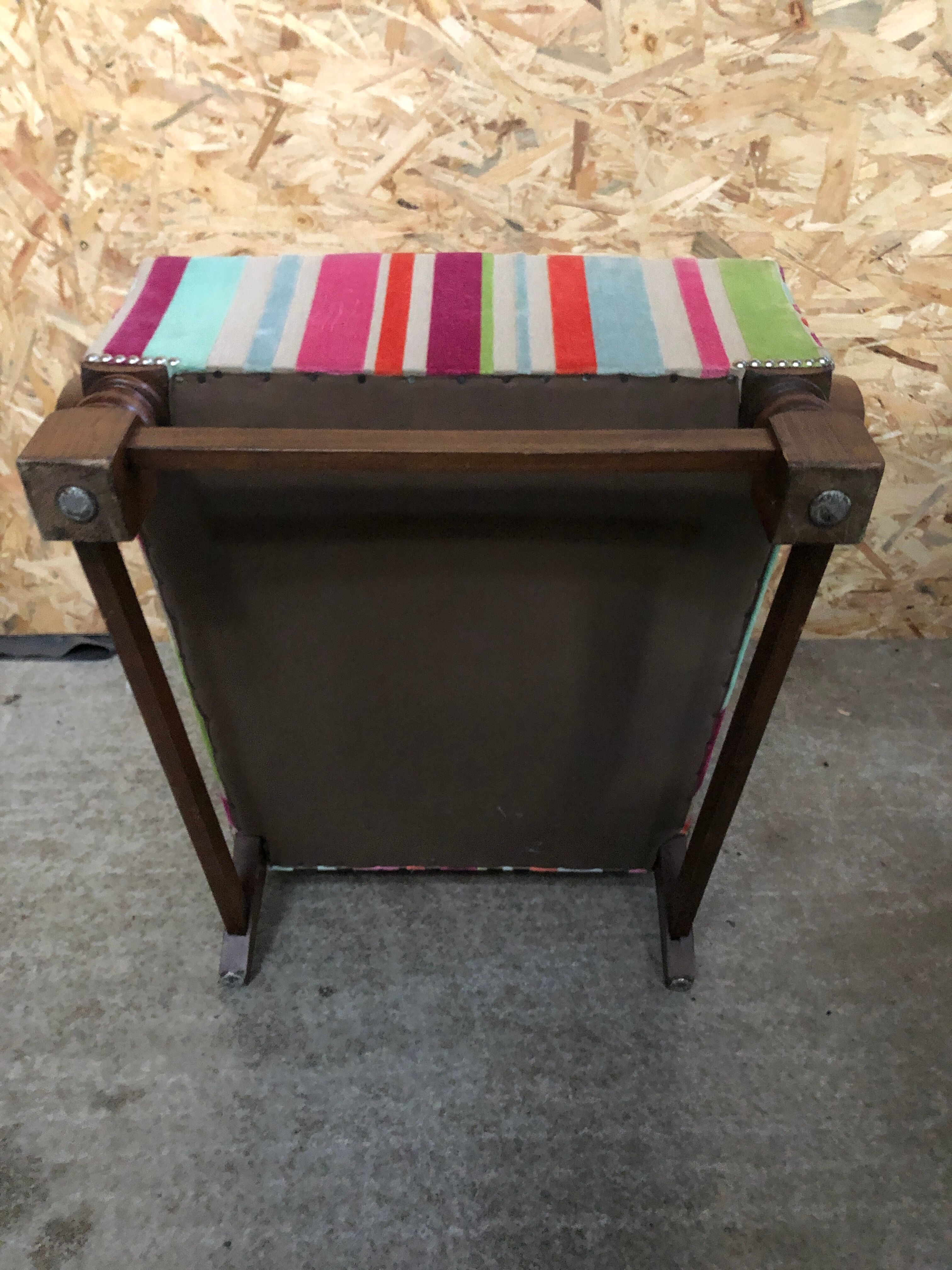Old wooden armchair with curved armrests
