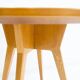 Round dining table in Wood Wood with brass details.