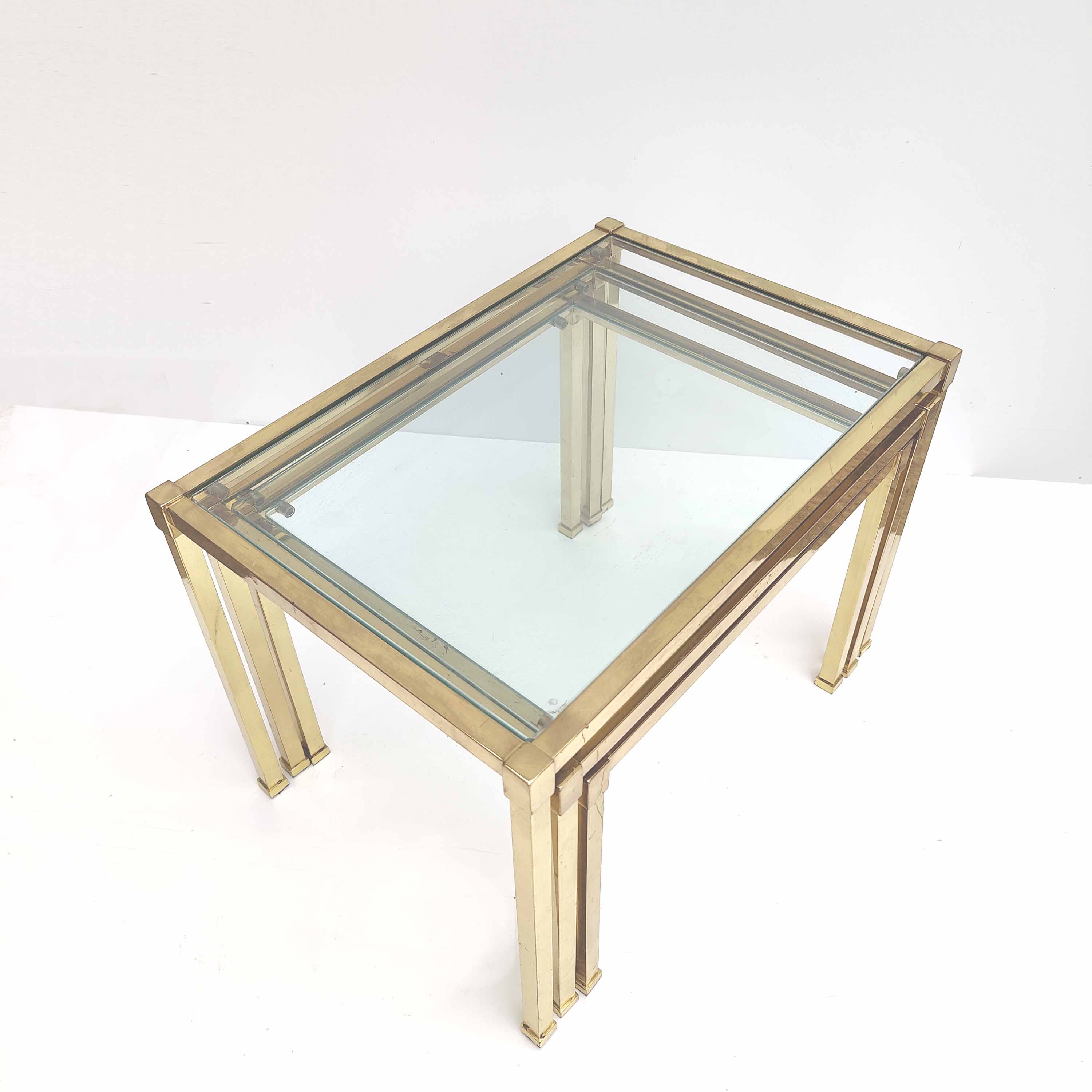 Brass and glass trundle tables