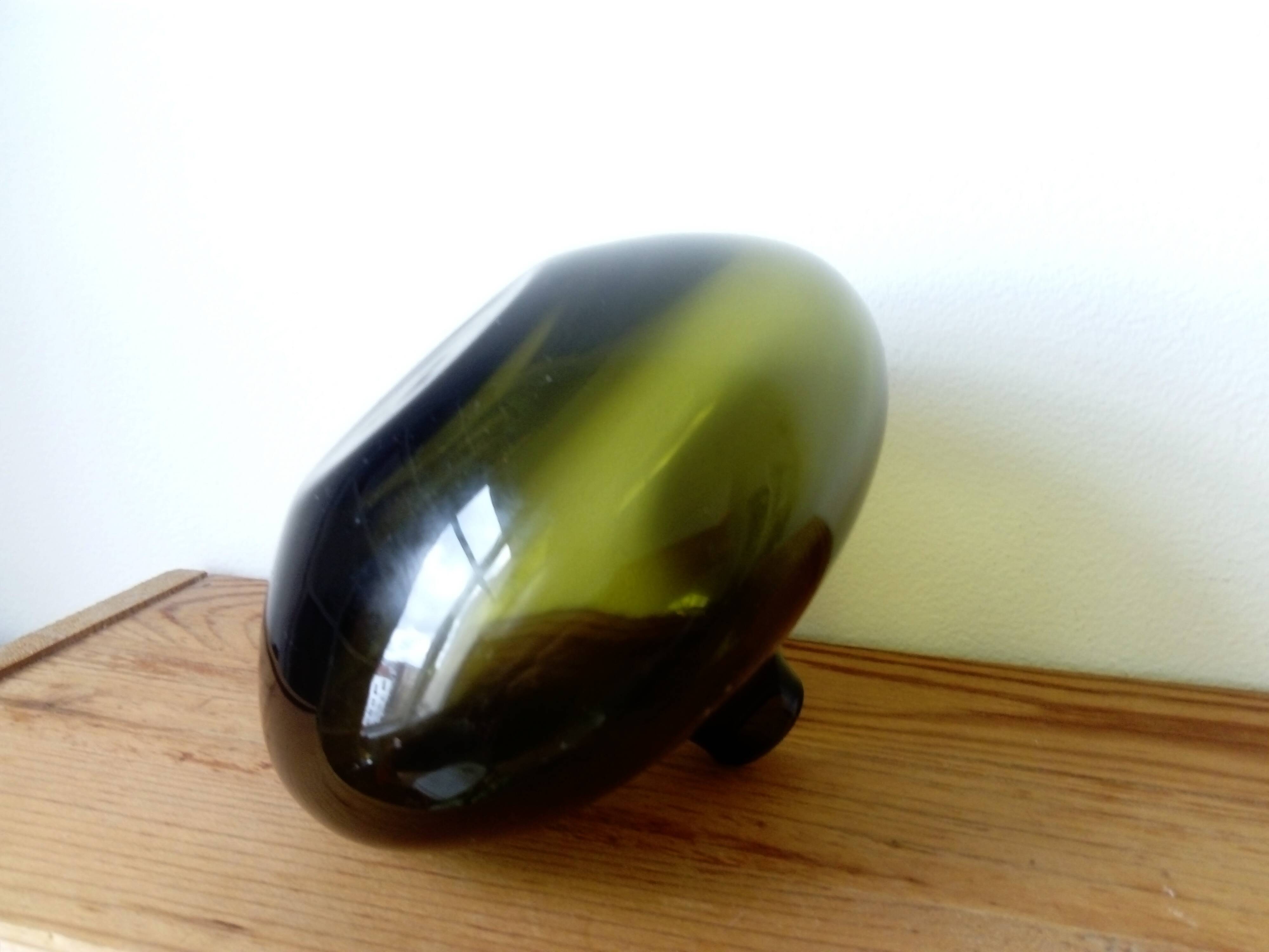 Small dark green handmade glass ball vase