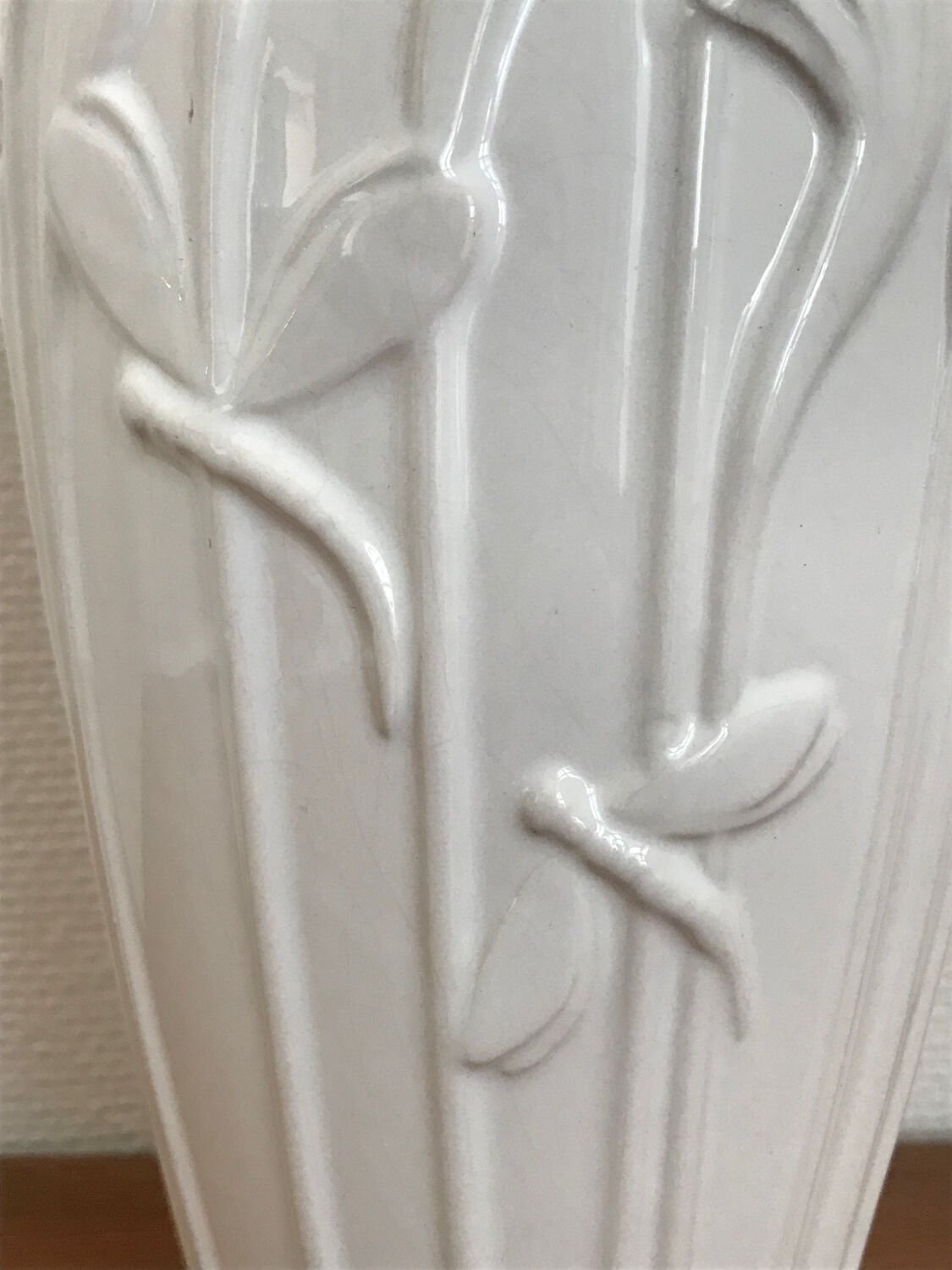 Old white art nouveau vase with flowers and dragonflies