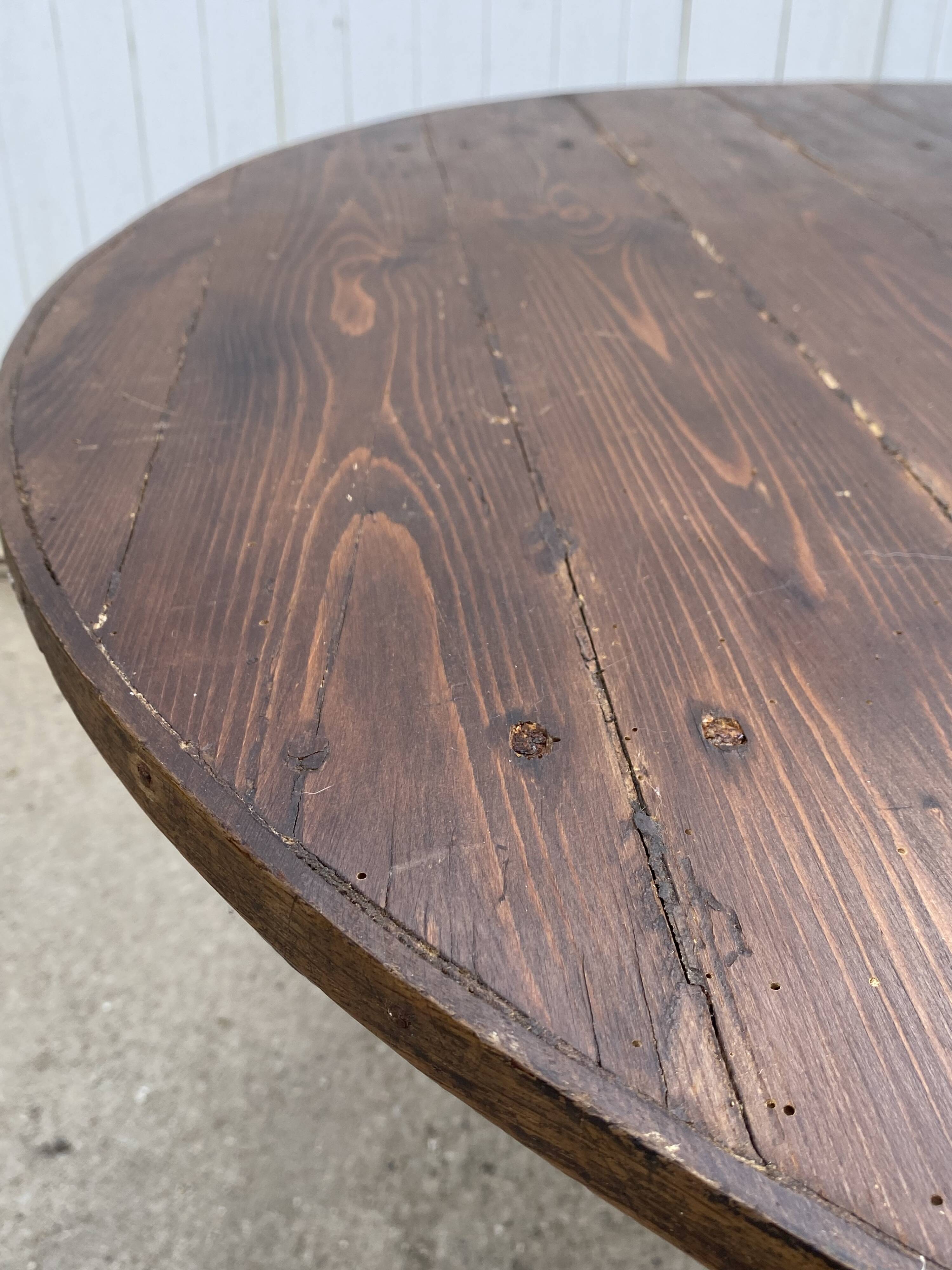 Old folding round winemaker's table with a tilting top.