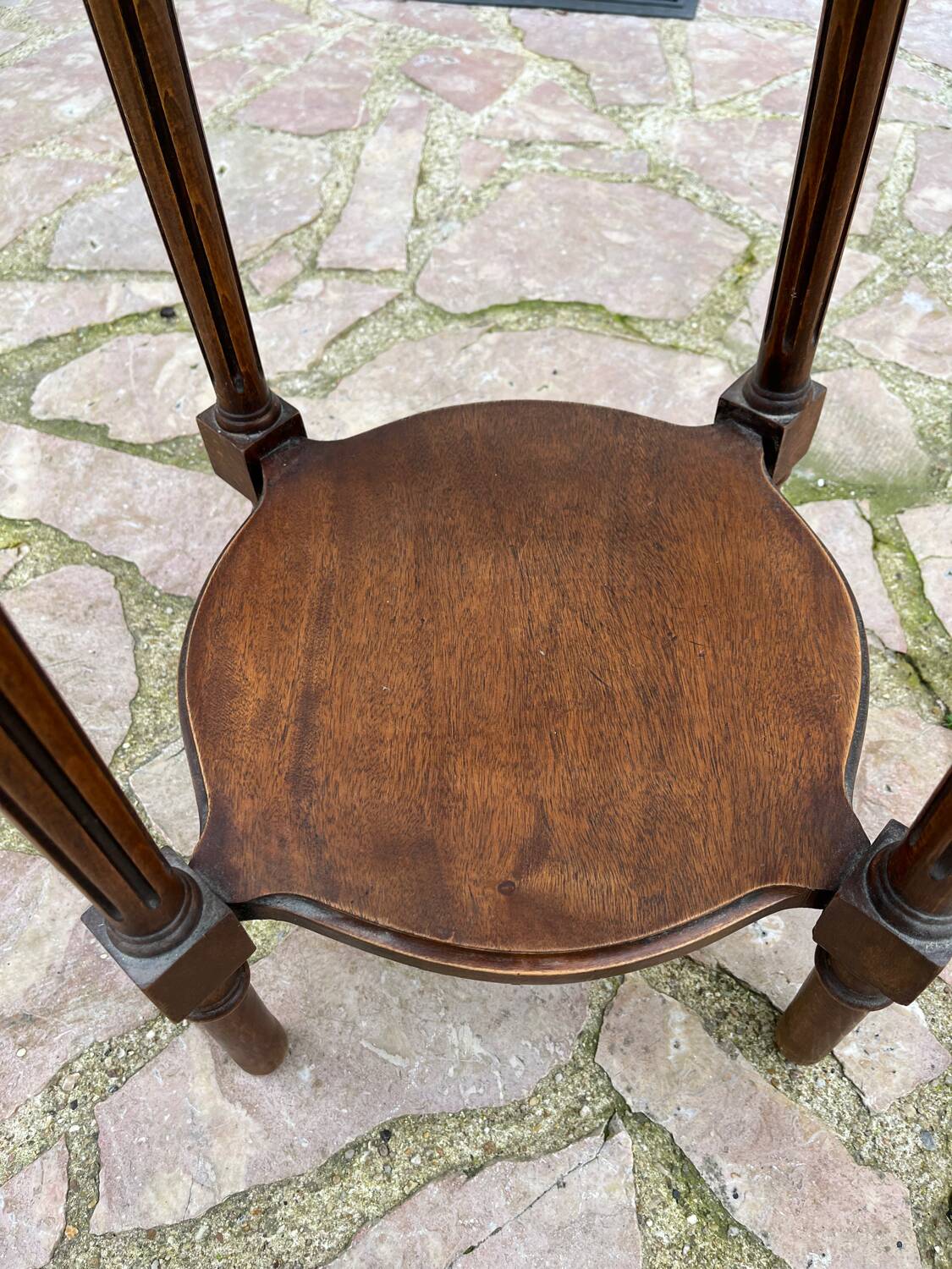 Old wooden pedestal table with marble top