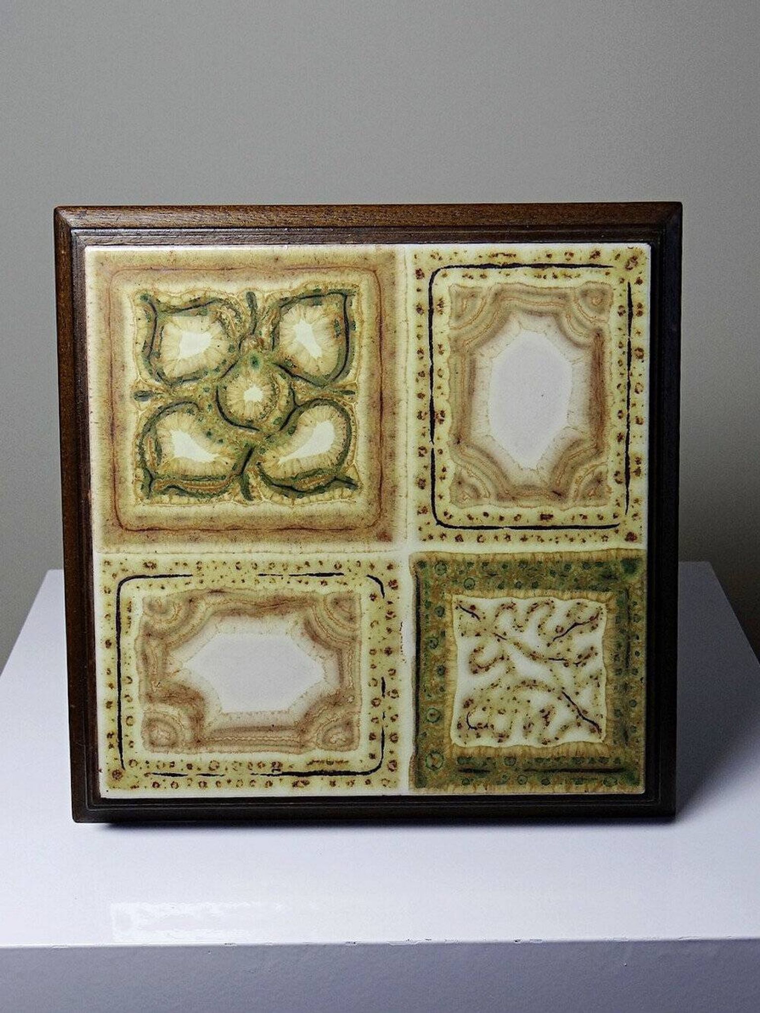 Vintage ceramic and wooden trivet, circa 1960-1970.
