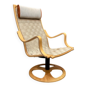 Swivel armchair and its Scandinavian design ottoman.