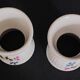 Pair of porcelain diabolo egg cups decorated with 20th century barbels