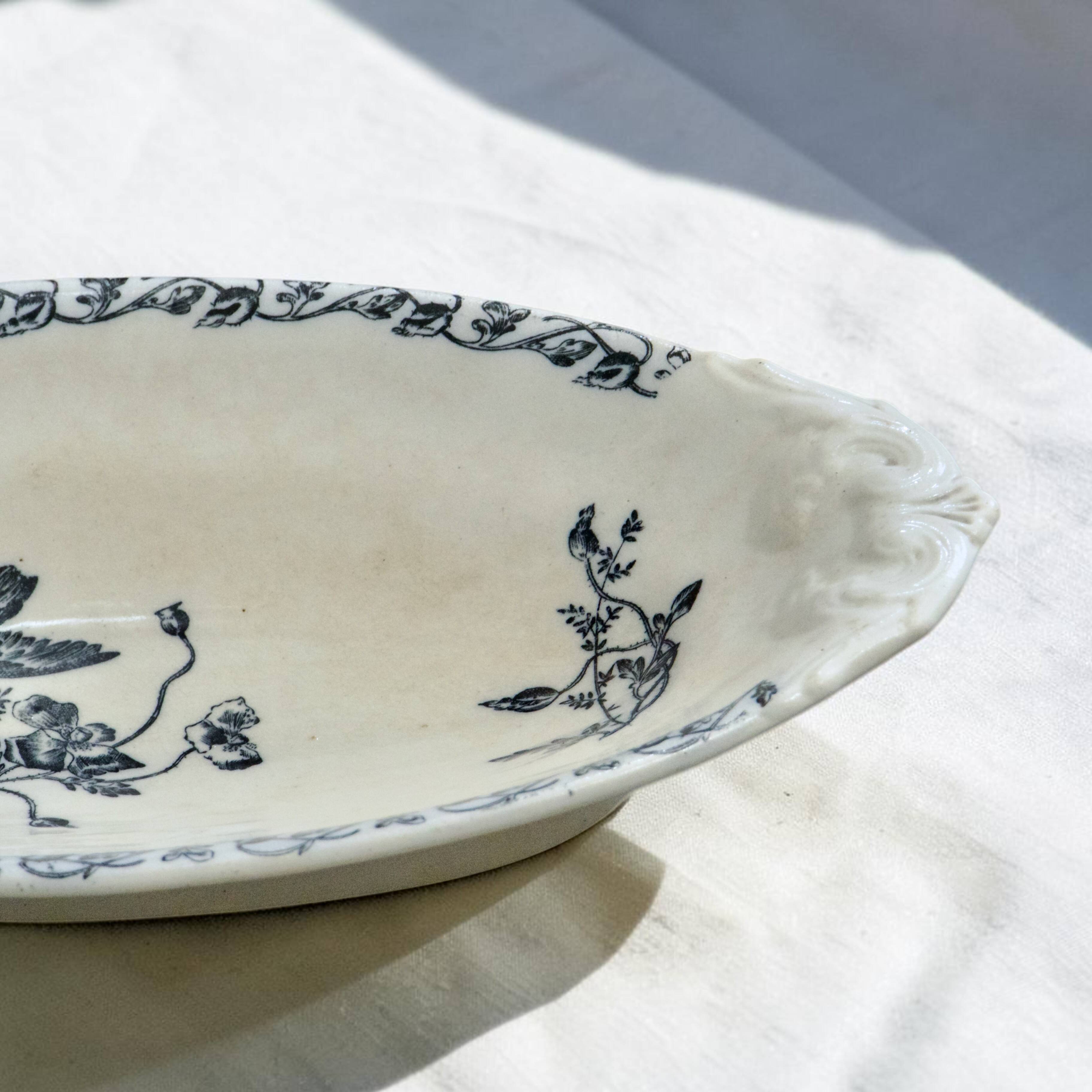 Iron flat plate with a 19th-century bird signed Onnaing "Poppies"