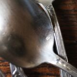 A set of 6 silver-plated metal soup spoons with foliage design.