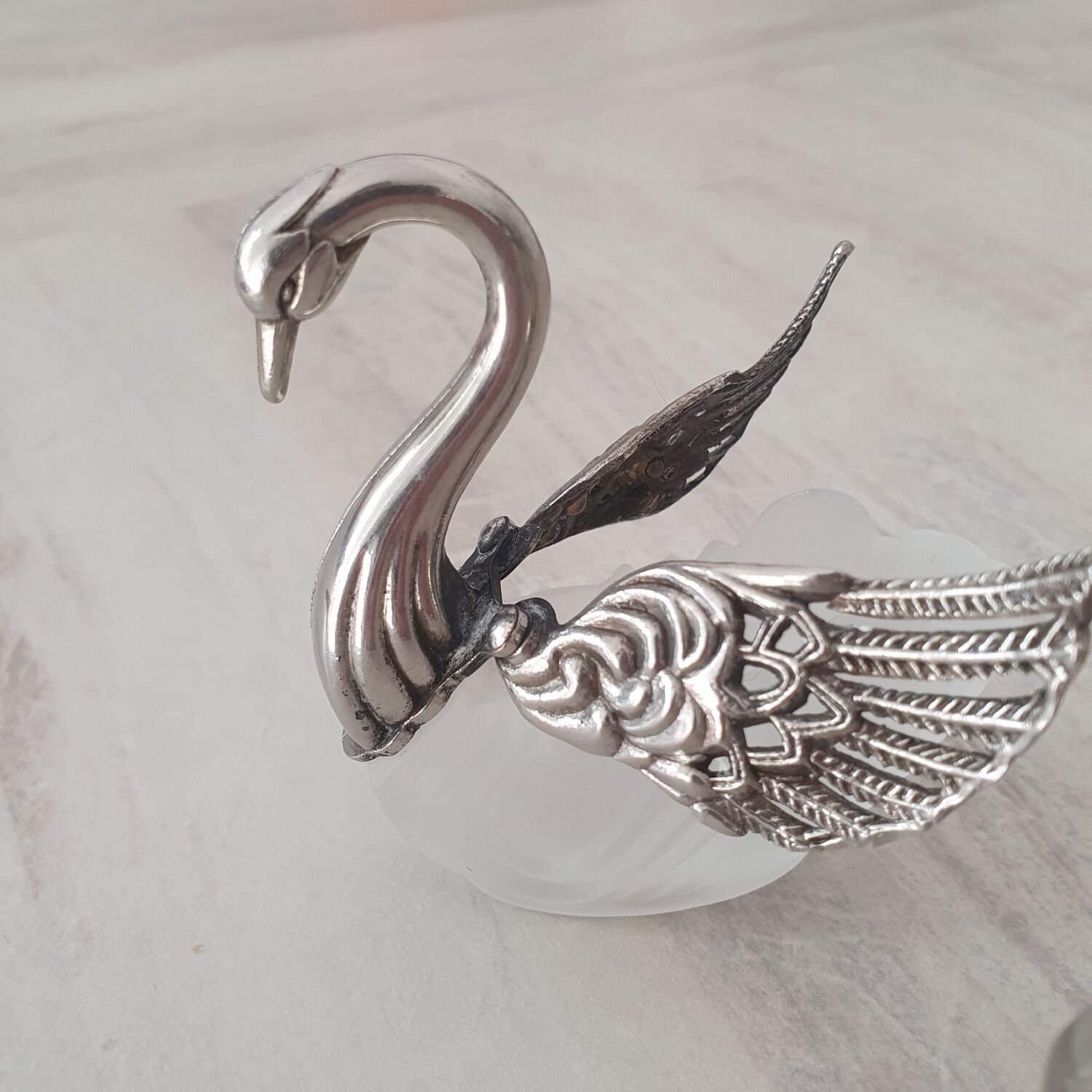 Two frosted glass swan salt cellars with silver plating.