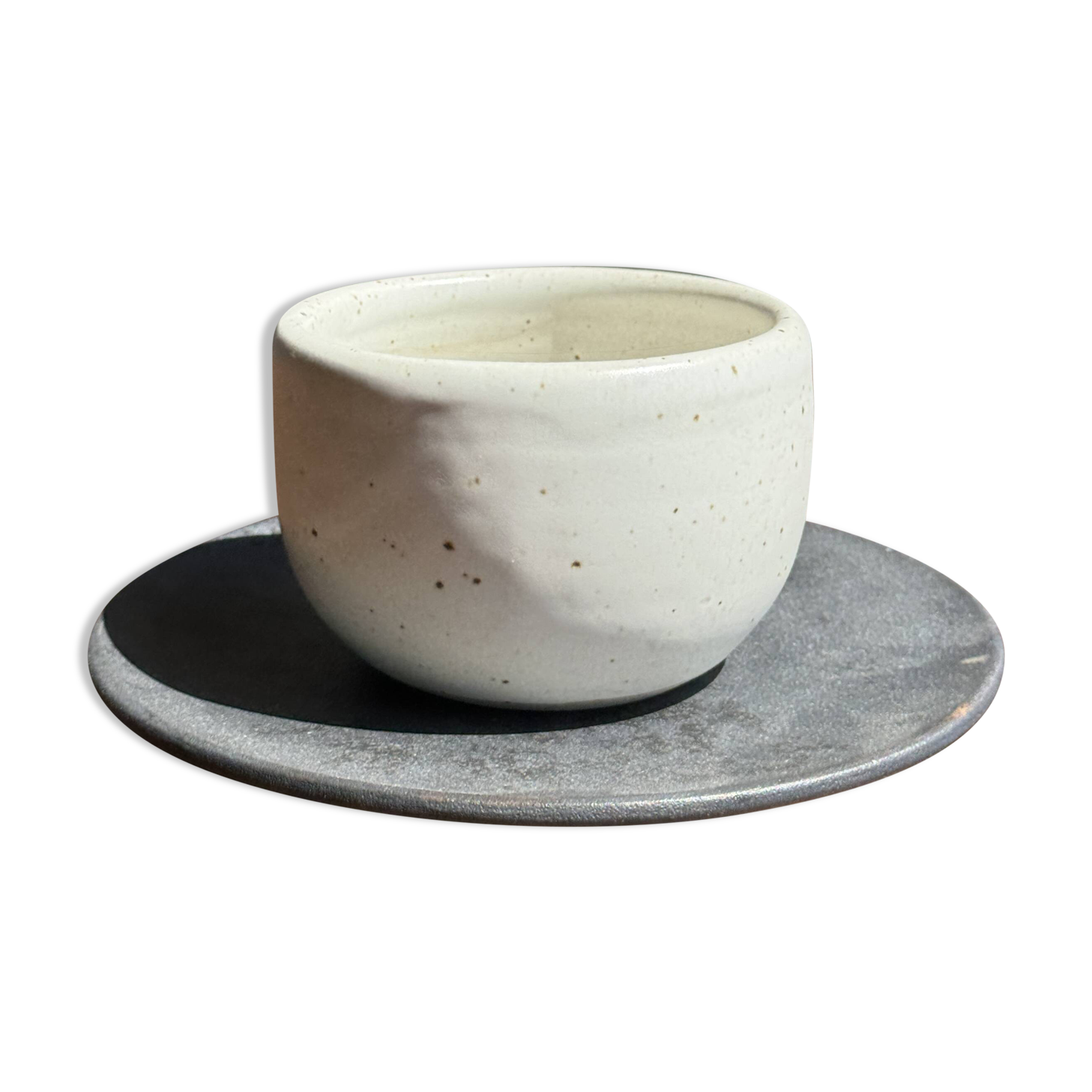 White Indonesian ceramic cup and gray saucer