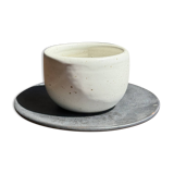 White Indonesian ceramic cup and gray saucer