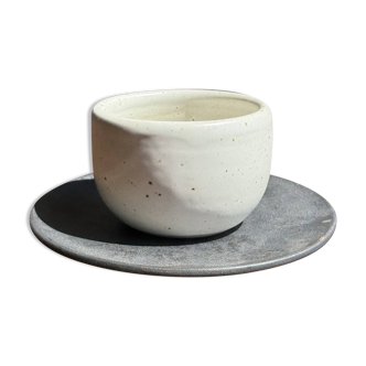 White Indonesian ceramic cup and gray saucer